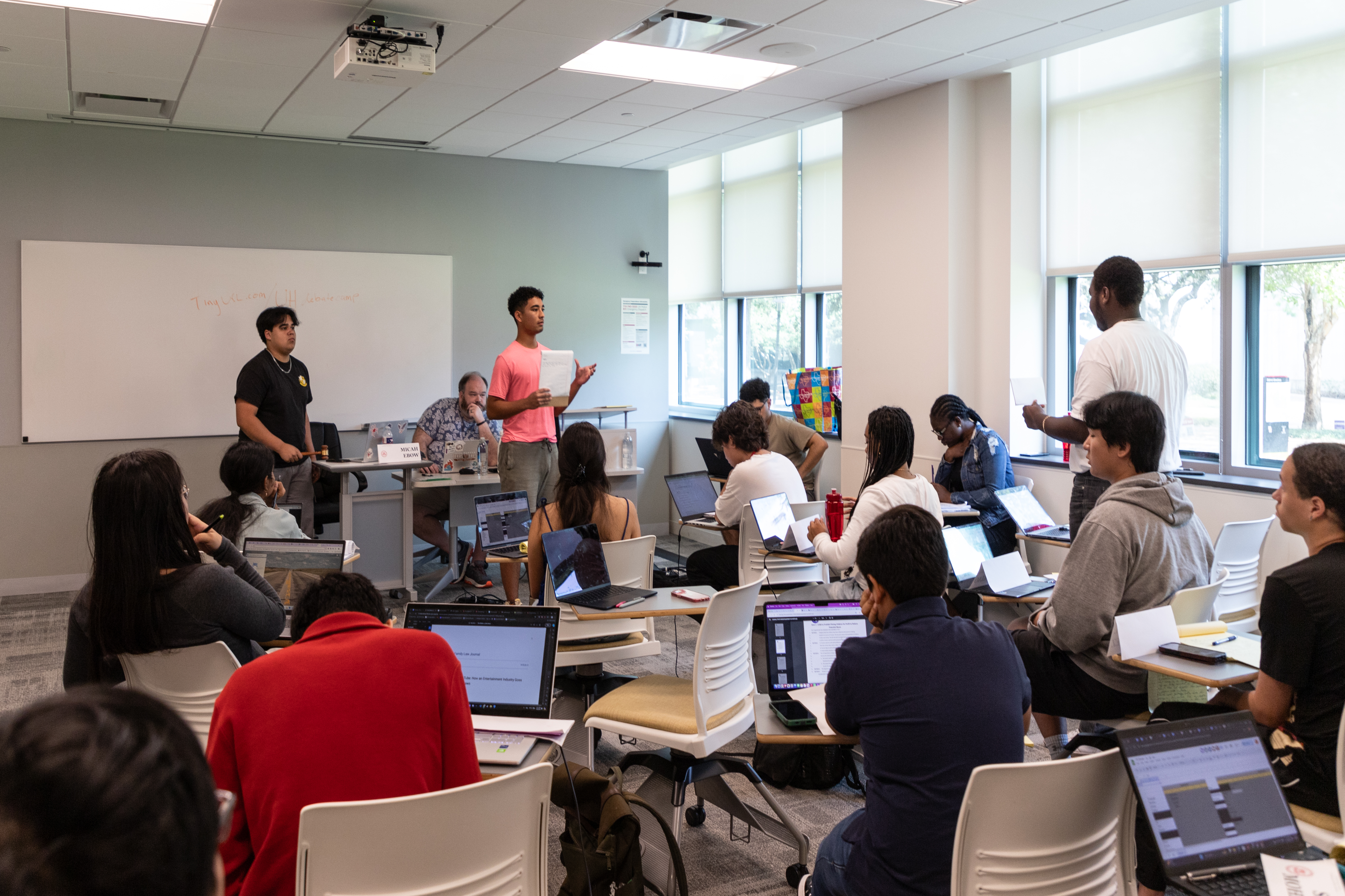 high school students practice debate in class